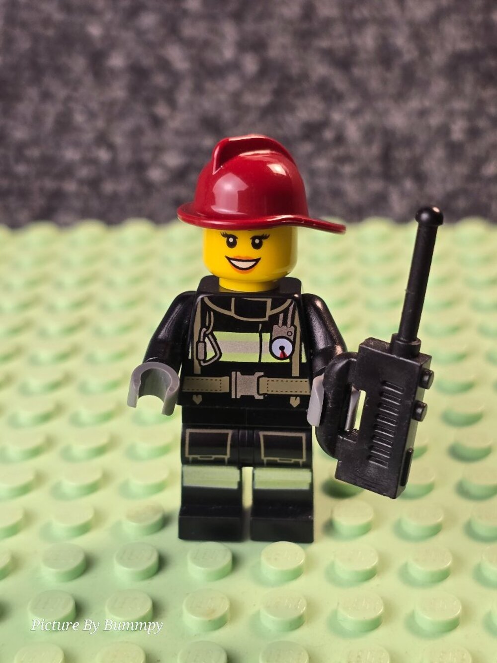 LEGO City Firefighter minifigure with a red helmet and a black suit
